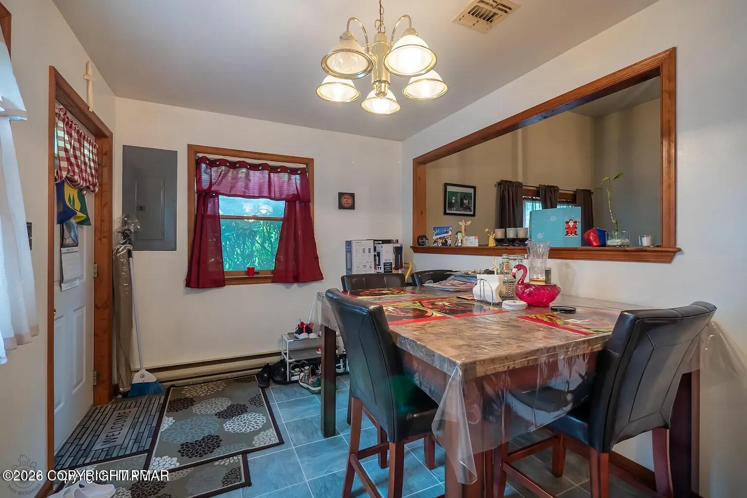 165 Old Stagecoach Road, Unit 3 Gilbert, PA 18331 - Photo 5 of 20 a view of a dining room with furniture and a chandelier