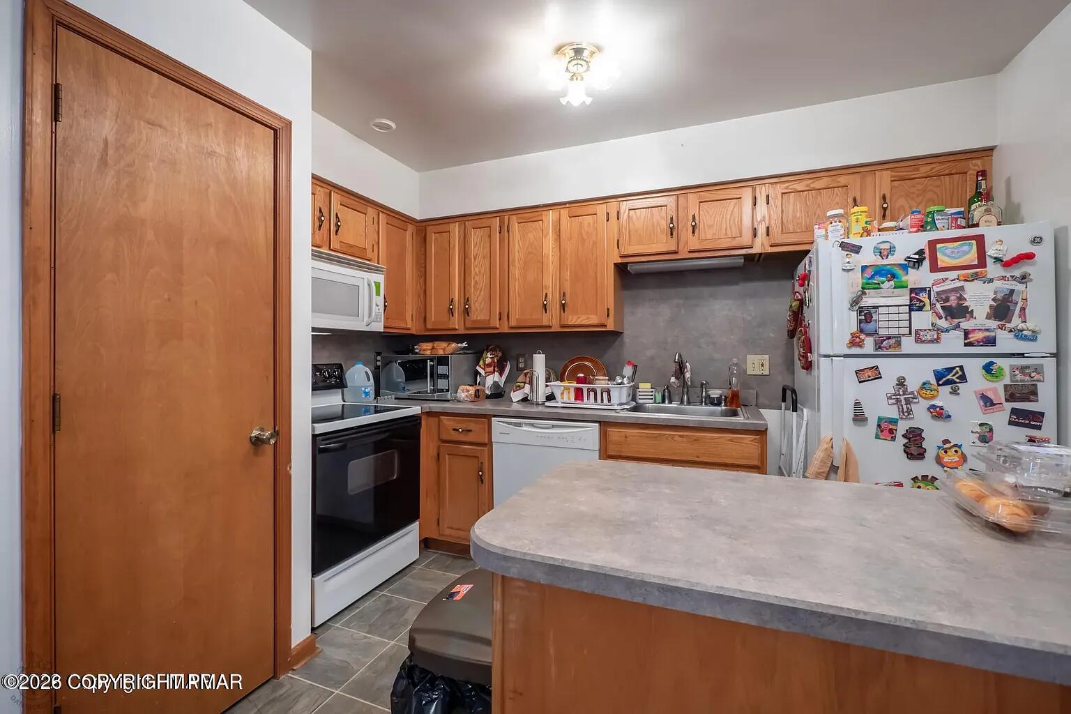 165 Old Stagecoach Road, Unit 3 Gilbert, PA 18331 - Photo 7 of 20 a kitchen with stainless steel appliances granite countertop a refrigerator and a sink
