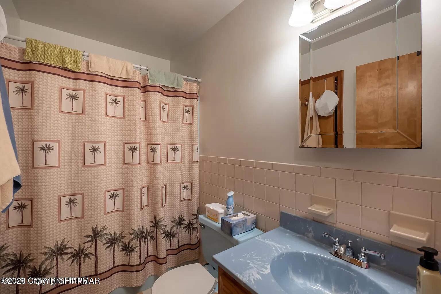 165 Old Stagecoach Road, Unit 3 Gilbert, PA 18331 - Photo 10 of 20 a bathroom with a sink and a mirror