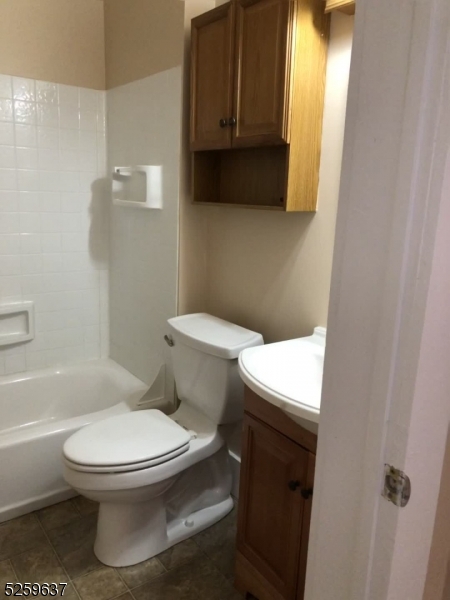 9 Moran Street, Unit 3 Newton, NJ 07860 - Photo 11 of 13 a white toilet sitting next to a bathroom sink and vanity