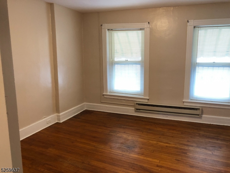 9 Moran Street, Unit 3 Newton, NJ 07860 - Photo 6 of 13 an empty room with wooden floor and windows
