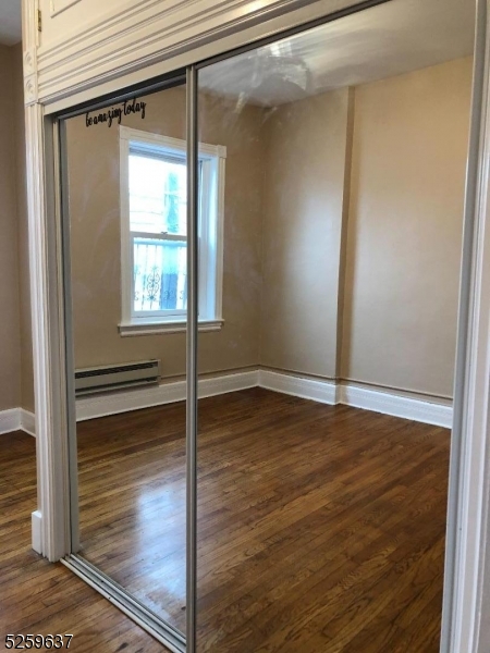 9 Moran Street, Unit 3 Newton, NJ 07860 - Photo 7 of 13 an empty room with wooden floor and windows