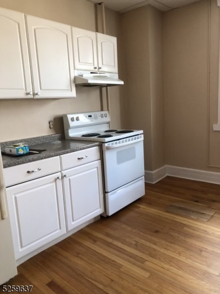 9 Moran Street, Unit 3 Newton, NJ 07860 - Photo 9 of 13 a kitchen with stainless steel appliances granite countertop a sink a stove a microwave and cabinets