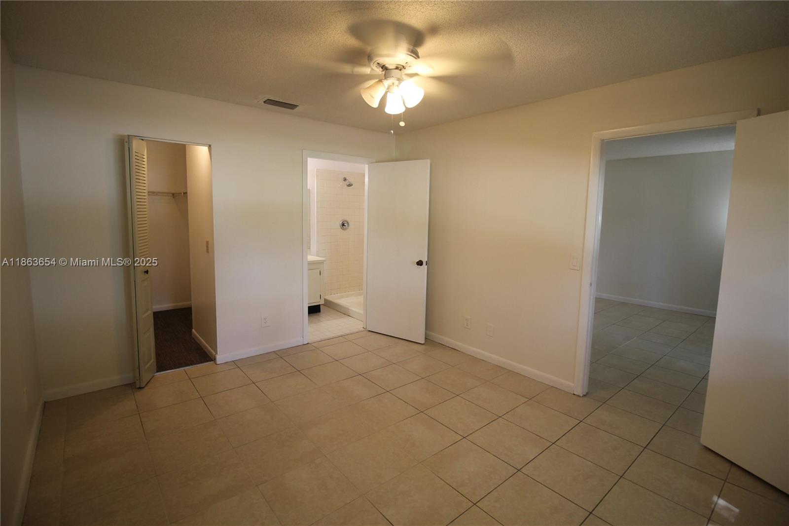 721 Northwest 103rd Terrace, Unit 202 Pembroke Pines, FL 33026 - Photo 11 of 24 a view of a room with a chandelier fan and closet