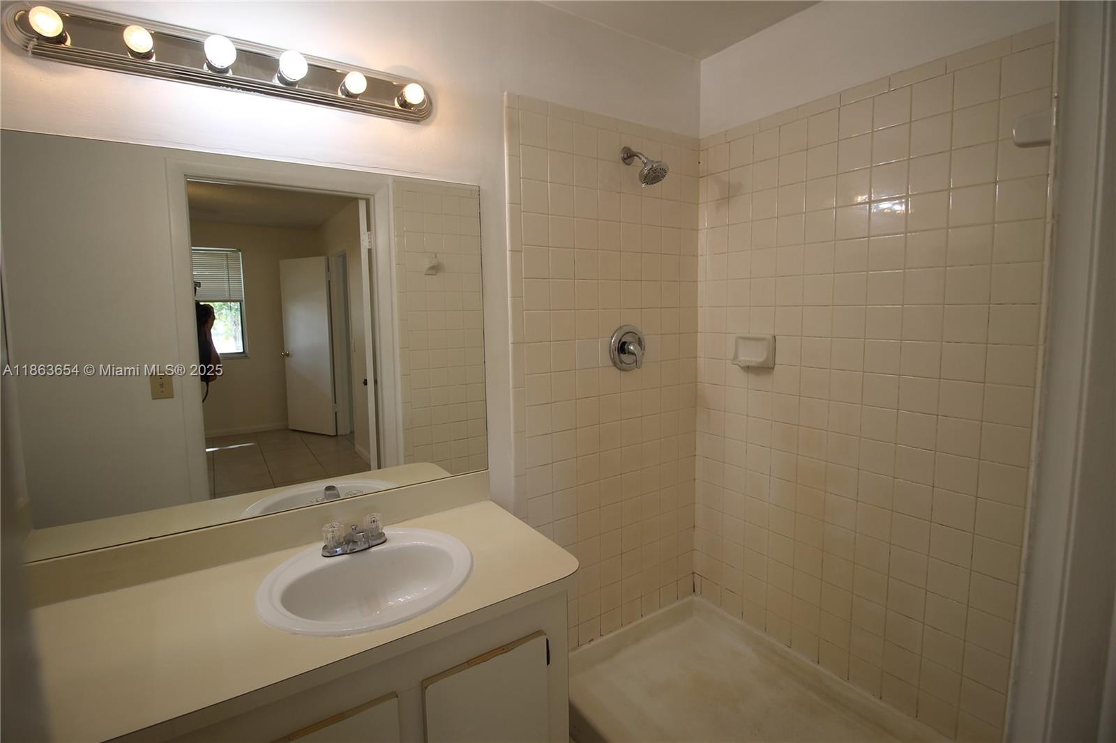 721 Northwest 103rd Terrace, Unit 202 Pembroke Pines, FL 33026 - Photo 12 of 24 a bathroom with a sink shower and a mirror