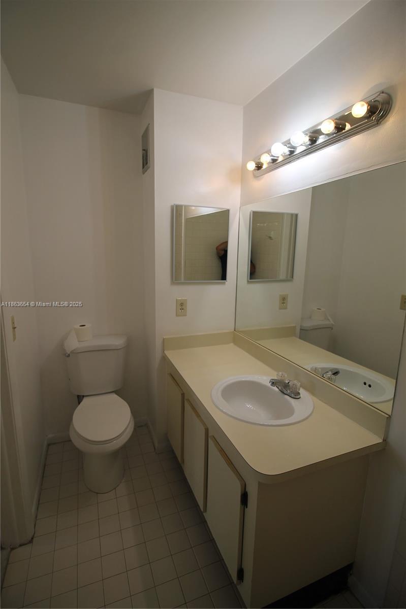 721 Northwest 103rd Terrace, Unit 202 Pembroke Pines, FL 33026 - Photo 13 of 24 a bathroom with a sink toilet and mirror