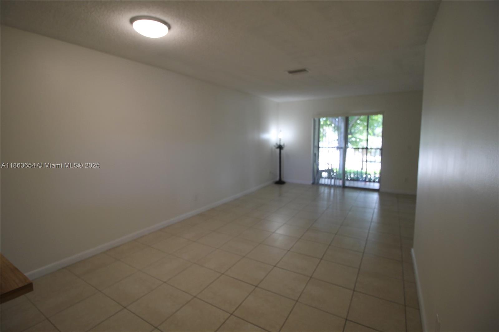 721 Northwest 103rd Terrace, Unit 202 Pembroke Pines, FL 33026 - Photo 2 of 24 an empty room with windows and closet