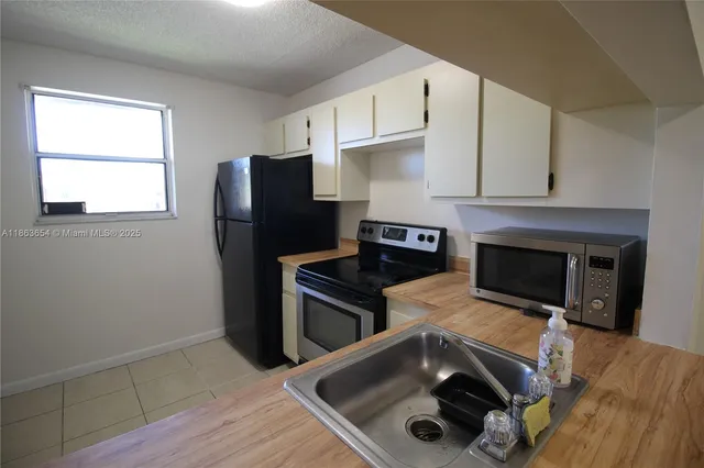 a kitchen that has a sink and a stove in it