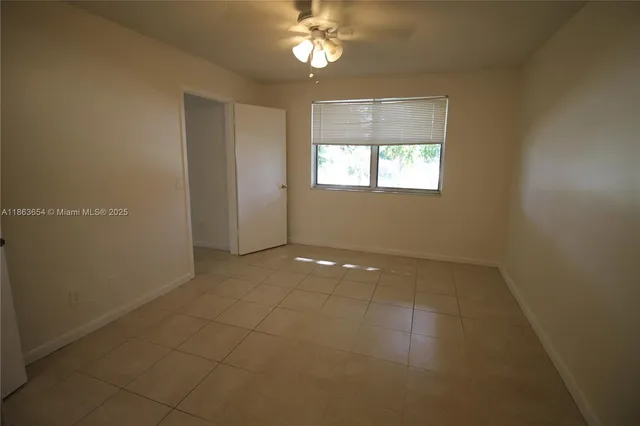 a bathroom with a sink shower and a mirror