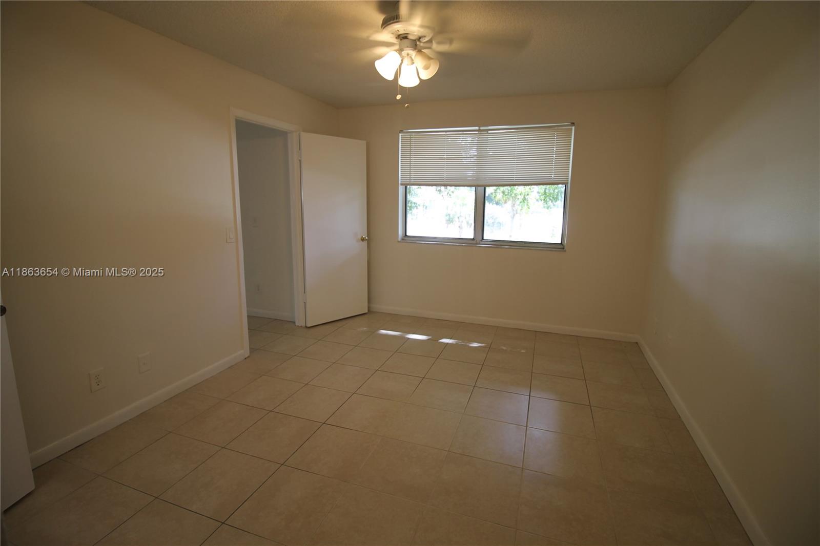 721 Northwest 103rd Terrace, Unit 202 Pembroke Pines, FL 33026 - Photo 10 of 24 a view of an empty room with a window