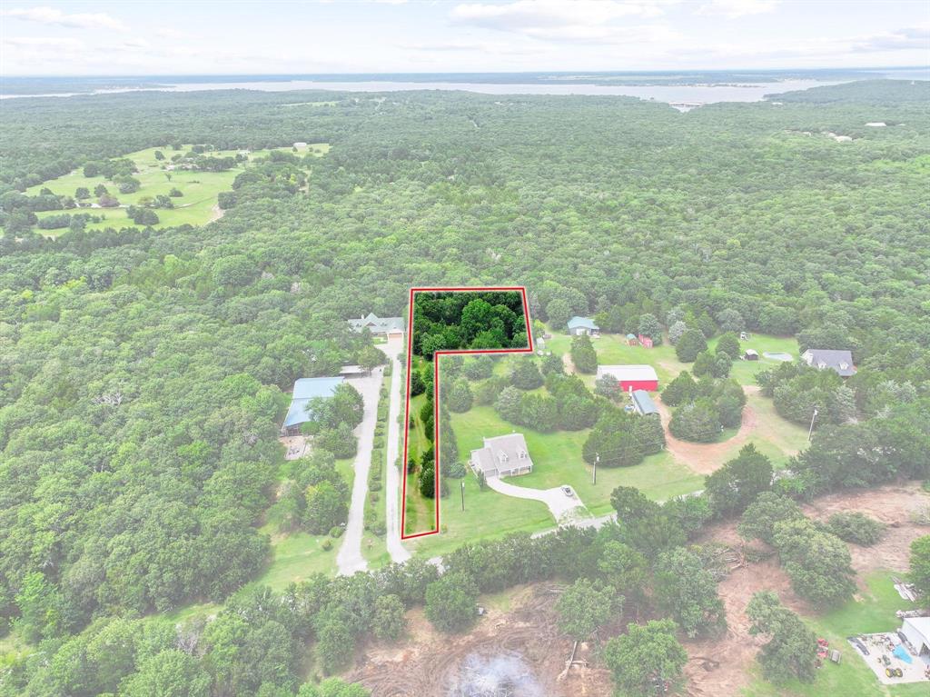 207 Paradise Park Road Pottsboro, TX 75076 - Photo 4 of 28 Expansive wooded parcel outlined in red, featuring a private drive and mature trees