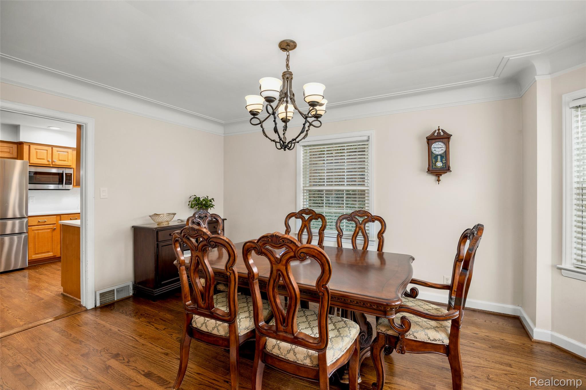 244 Kerby Road Grosse Pointe, MI 48236 - Photo 21 of 53 Dining room featuring dark wood finished floors, hanging lights, and crown molding