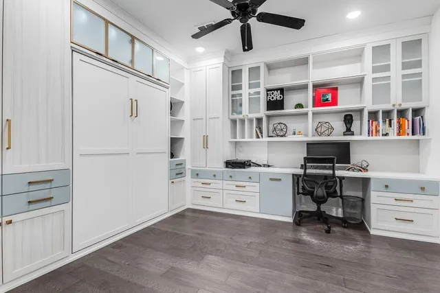 a view of a kitchen with white cabinets and wooden floor