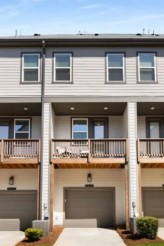 a front view of a building with a garden