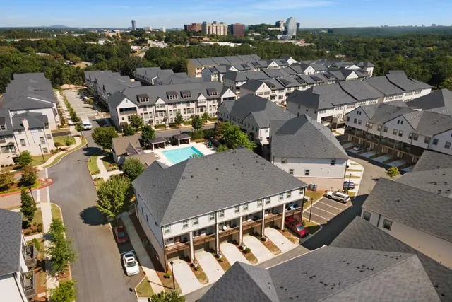 a view of a roof deck with couches and wooden fence