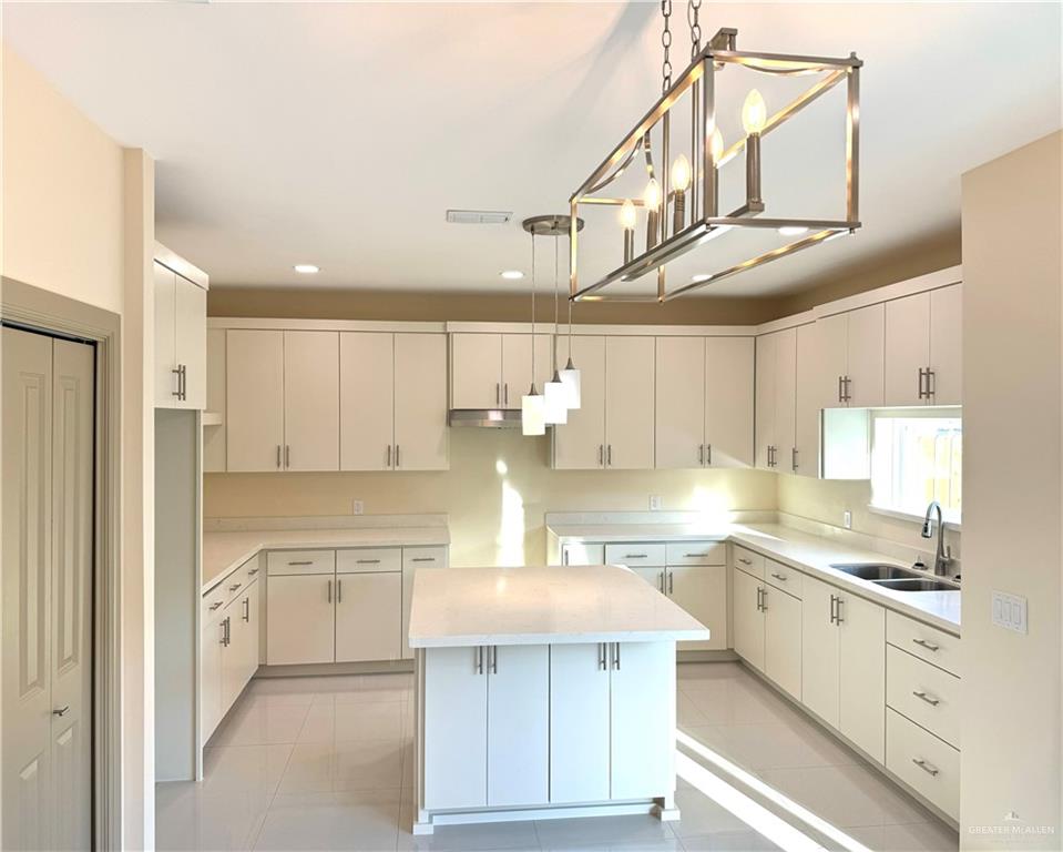 2810 Stablewood Mission, TX 78574 - Photo 5 of 18 a kitchen with kitchen island a sink stainless steel appliances and cabinets