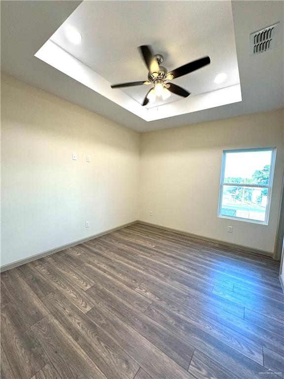 2810 Stablewood Mission, TX 78574 - Photo 10 of 18 an empty room with wooden floor and windows
