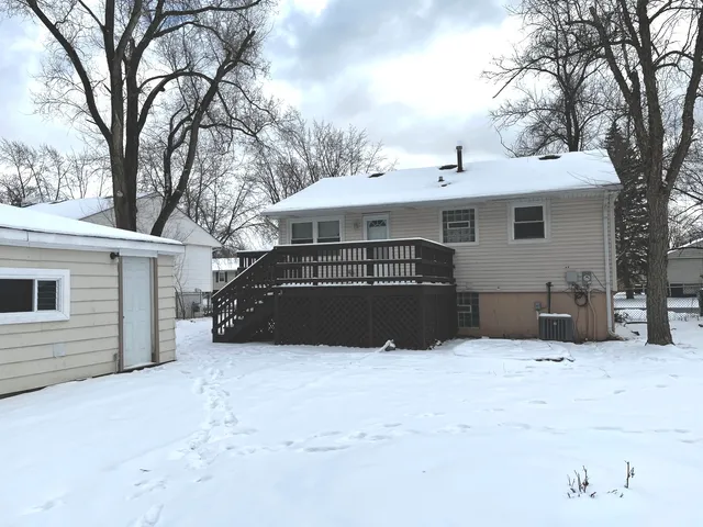 a white house that has a tree in front of it