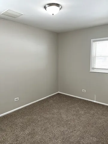 an empty room with closet and wooden door