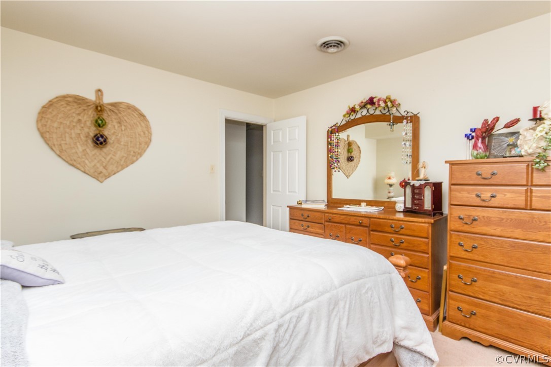 14010 Fiddlers Ridge Road Midlothian, VA 23112 - Photo 28 of 36 a bedroom with a bed and a chandelier
