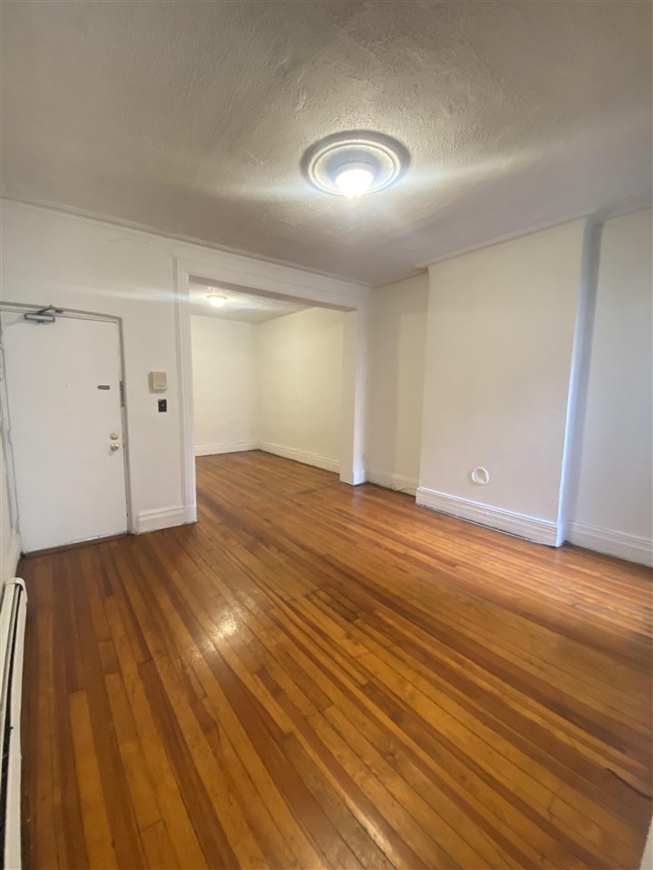 112 14th Street, Unit 7 Hoboken, NJ 07030 - Photo 2 of 8 a view of empty room with wooden floor
