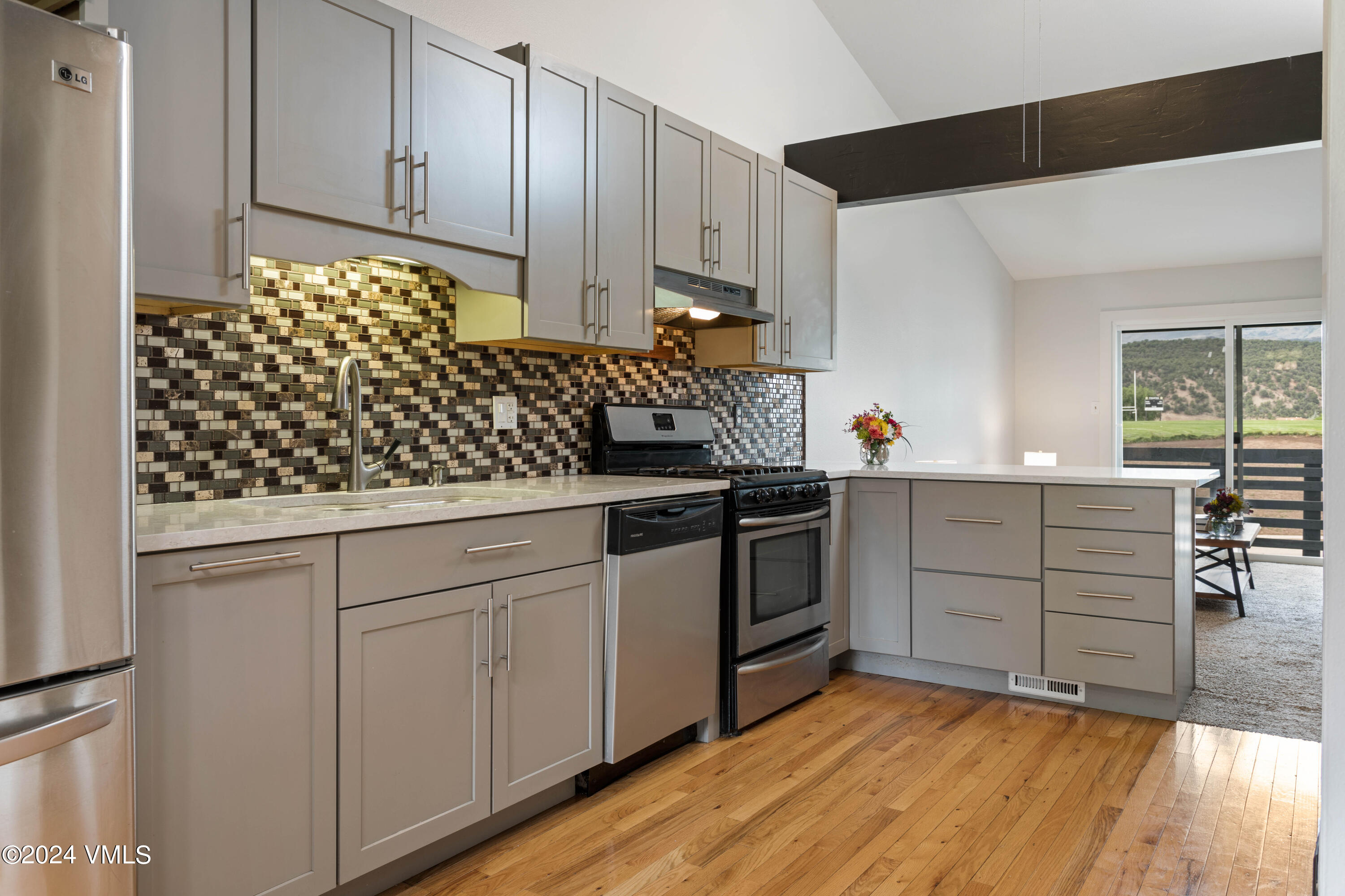528 East 3rd Street Eagle, CO 81631 - Photo 2 of 17 a kitchen with stainless steel appliances granite countertop a sink stove and cabinets