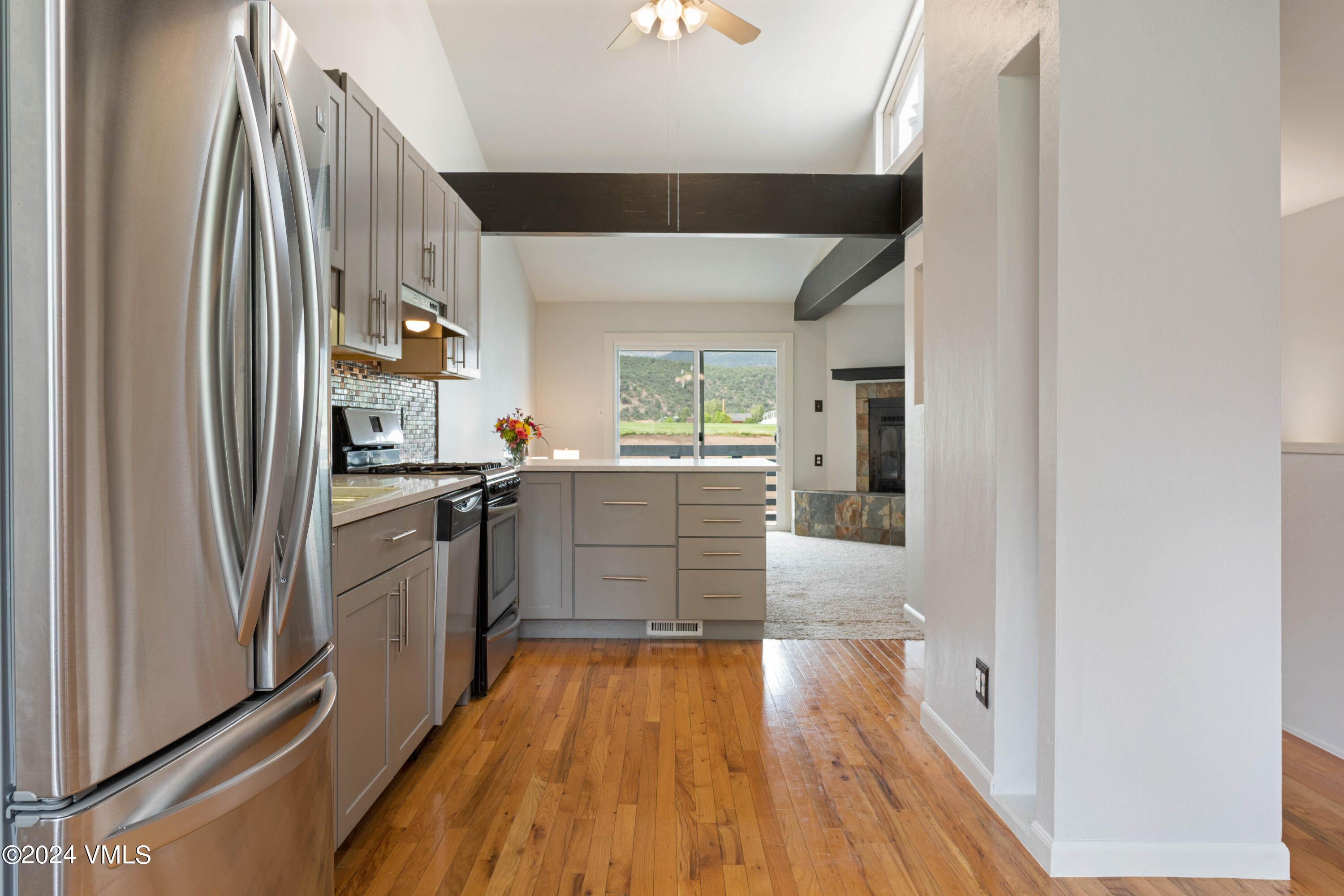 528 East 3rd Street Eagle, CO 81631 - Photo 3 of 17 a kitchen with stainless steel appliances a refrigerator and a stove top oven
