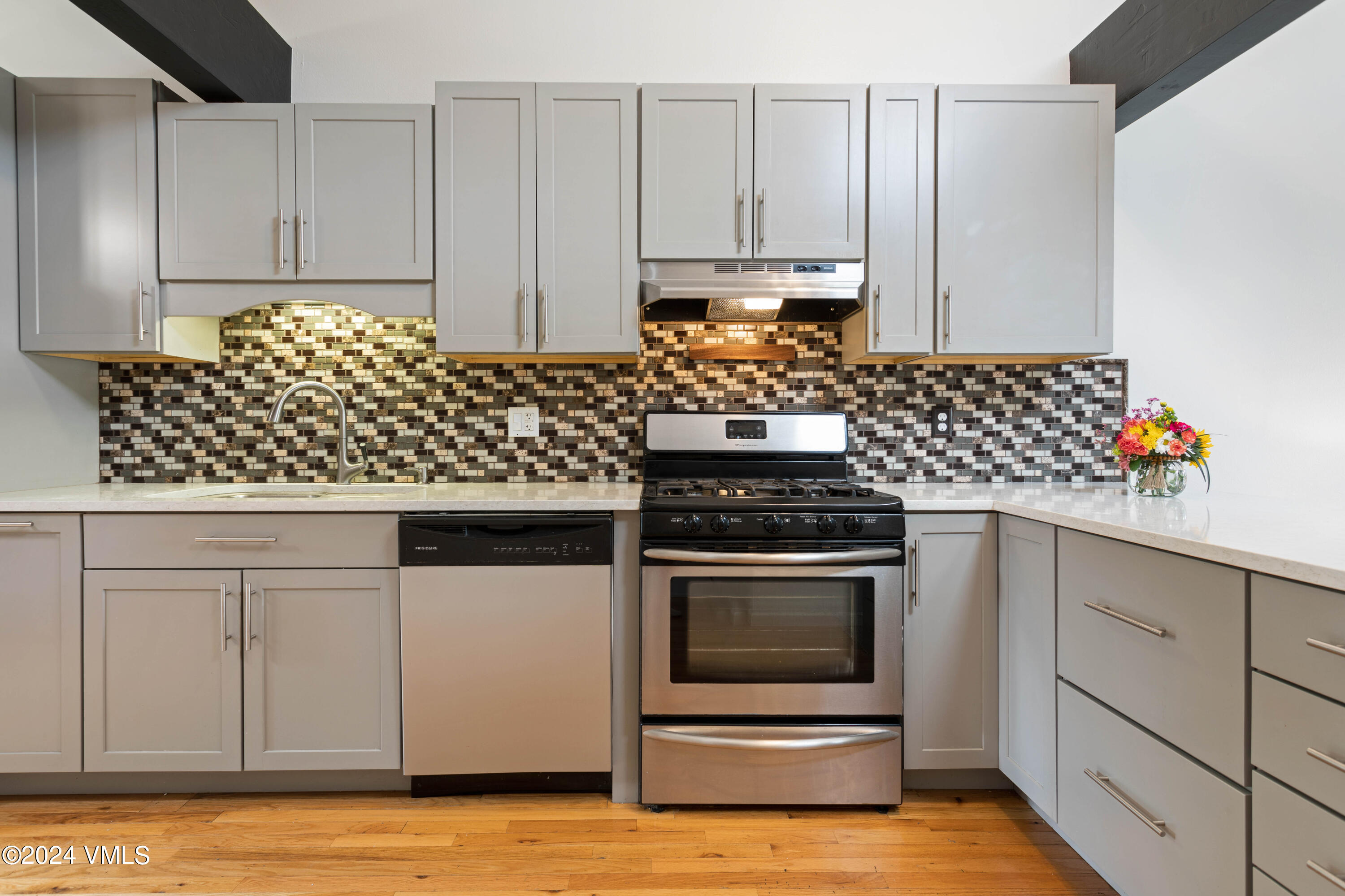528 East 3rd Street Eagle, CO 81631 - Photo 6 of 17 a kitchen with stainless steel appliances granite countertop white cabinets a stove a sink and dishwasher