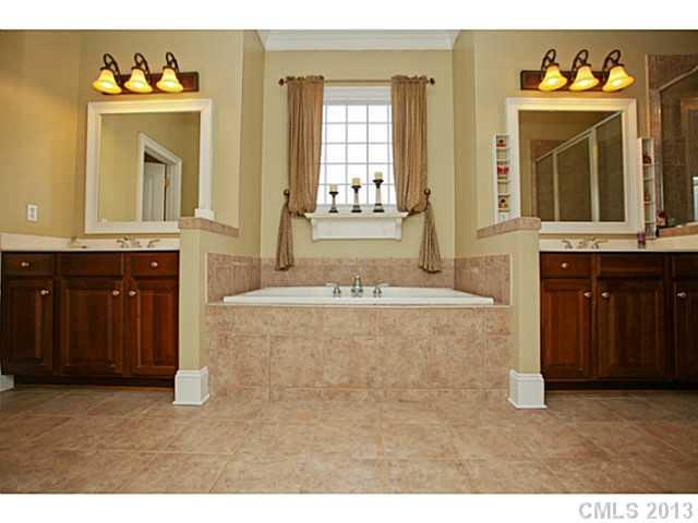 501 St Ives Court Fort Mill, SC 29708 - Photo 11 of 16 a spacious bathroom with a tub sink and mirror
