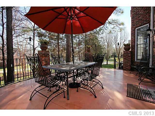 501 St Ives Court Fort Mill, SC 29708 - Photo 15 of 16 a view of a patio with a table and chairs under an umbrella