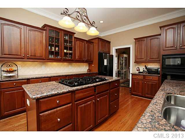 501 St Ives Court Fort Mill, SC 29708 - Photo 4 of 16 a kitchen with wooden cabinets and appliances