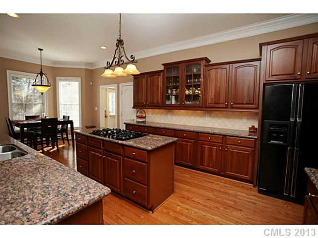 501 St Ives Court Fort Mill, SC 29708 - Photo 5 of 16 a kitchen with stainless steel appliances granite countertop a stove refrigerator and cabinets