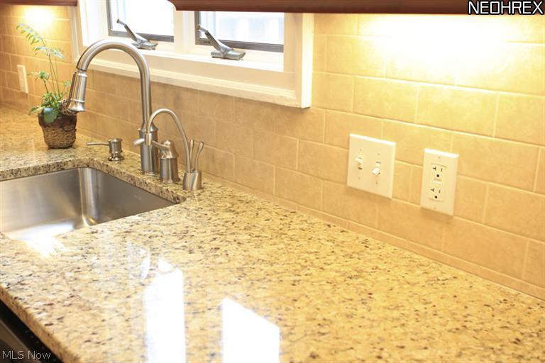 15803 Fernway Road Cleveland, OH 44120 - Photo 9 of 25 This close-up of the counters and sink highlight the sleekness of design in this Kitchen!