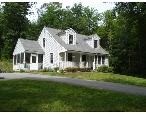 128 Haynes Road Townsend, MA 01469 - Photo 1 of 12 a front view of a house with a yard table and chairs