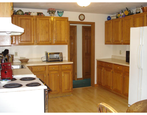 128 Haynes Road Townsend, MA 01469 - Photo 2 of 12 a kitchen with a sink a stove and a refrigerator