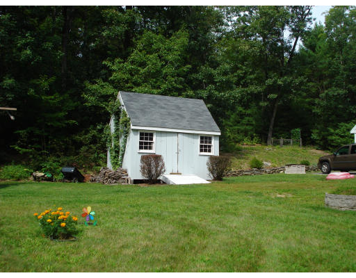 128 Haynes Road Townsend, MA 01469 - Photo 10 of 12 a front view of a house with a yard and trees