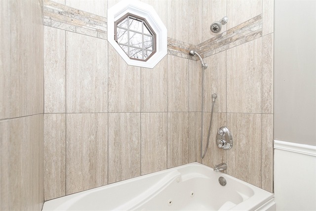 981 West Bauer Road Naperville, IL 60563 - Photo 15 of 21 a bathroom with a white bath tub and a shower curtain