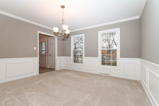 981 West Bauer Road Naperville, IL 60563 - Photo 4 of 21 an empty room with chandelier and windows