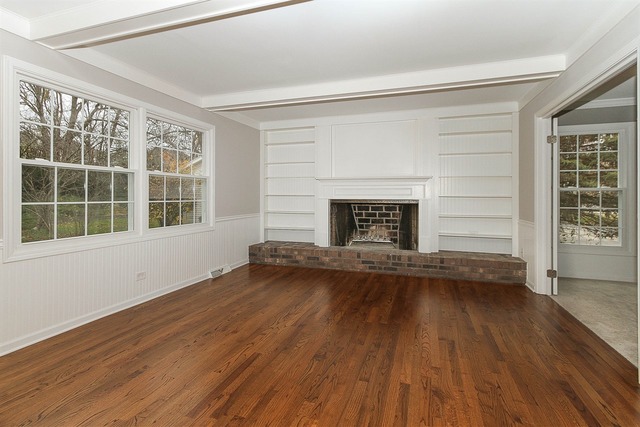 981 West Bauer Road Naperville, IL 60563 - Photo 9 of 21 a view of empty room with wooden floor and fireplace
