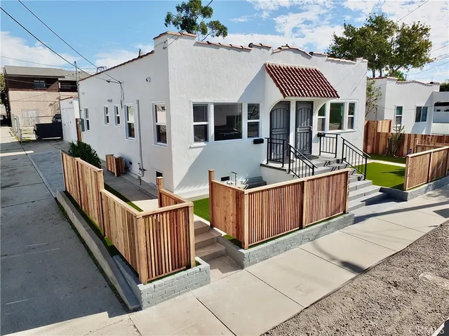 a front view of a house with wooden fence