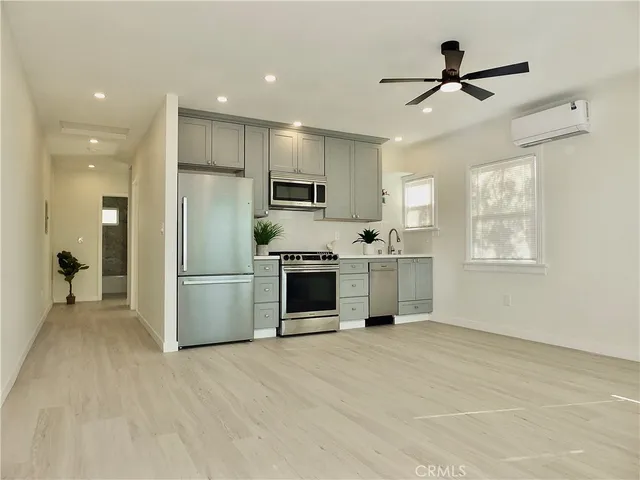 a kitchen with a refrigerator and a sink