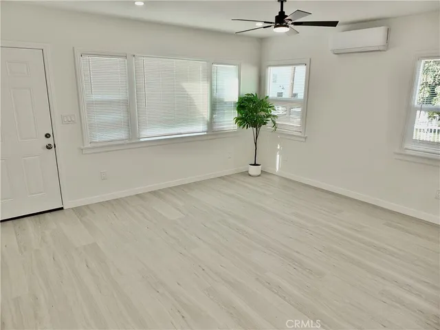 an empty room with windows and entrance