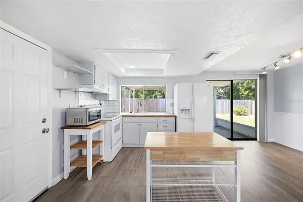 a kitchen with stainless steel appliances a stove top oven a sink dishwasher and a refrigerator