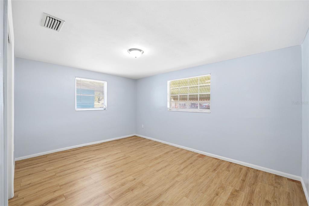 3303 Williamsburg Loop Holiday, FL 34691 - Photo 22 of 31 an empty room with wooden floor and windows