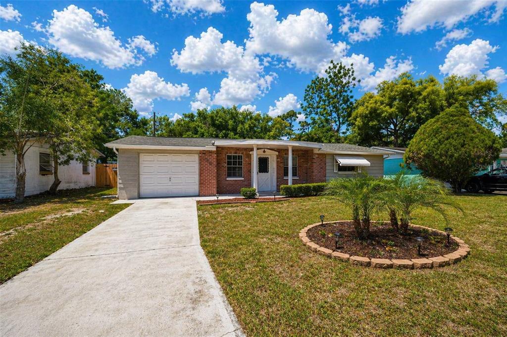3303 Williamsburg Loop Holiday, FL 34691 - Photo 3 of 31 a front view of a house with a yard
