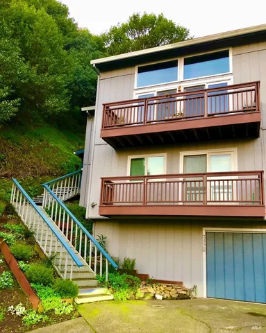 a view of a house with a wooden deck