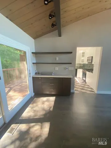 a kitchen with a refrigerator and a sink