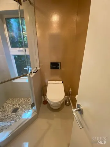 a bathroom with a shower and a toilet