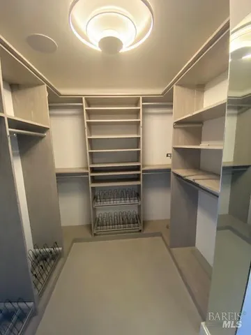 a kitchen with white cabinets and window