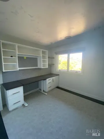 a view of empty room with furniture and fireplace